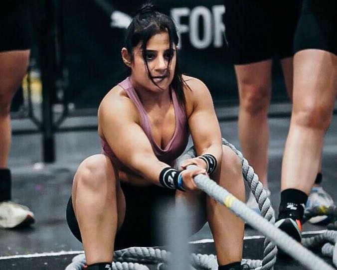 Female NewWave Fitness Athlete with Determined Look Pulls a Hyrox Sled